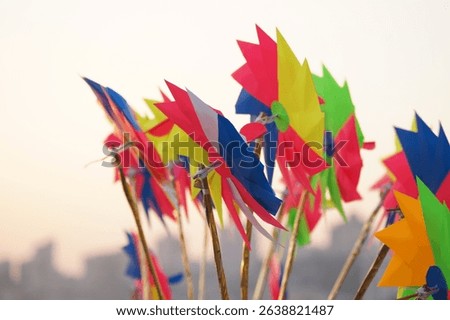Colorful Paper Pinwheels at Sunset. Multicolored paper pinwheels. Traditional handmade toys. Paper windmills. Indian street toys.