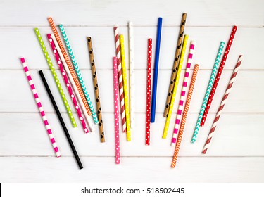 Colorful Paper Straws On White Wooden Background. Event And Party Supplies.