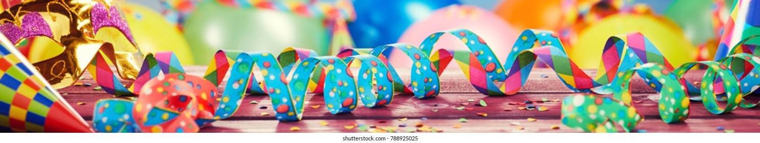 Colorful party, carnival or holiday banner with multicolored twirled ribbons or streamers, balloons and confetti in a wide panorama - Shutterstock ID 788925025