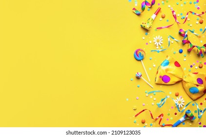 Colorful party items for carnival or birthday party on yellow background - Shutterstock ID 2109123035