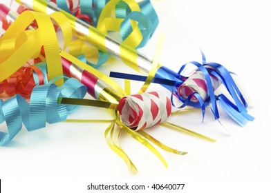 Colorful Party Supplies With Ribbons And Party Blowers,  On White Background With Copy Space, Selective Focus