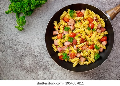 Colorful Pasta Rotini, Cherry Tomatoes And Ham On Pan. Top View.