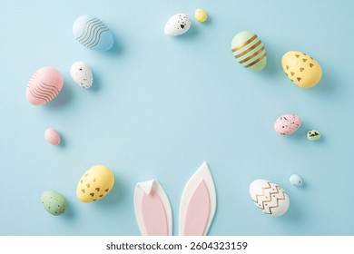 Colorful pastel Easter eggs arranged around pink bunny ears on a soft blue backdrop - Powered by Shutterstock - Get 15% off with code: PIKWIZARD15