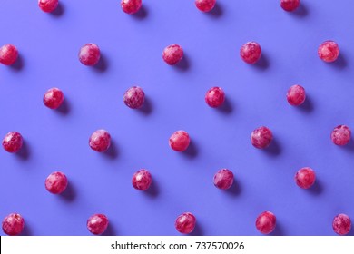 Colorful pattern of grapes on purple background. From top view
