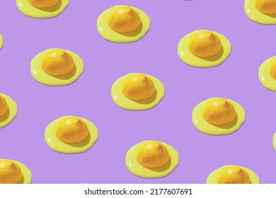 Colorful pattern with half of lemon dipped in yellow liquid on bright purple background. Global warming idea. Hot summer wallpaper. - Powered by Shutterstock