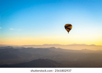 Colorful pattern hot air balloon in the skies over the Phoenix Arizona Sonoran Desert. Photo taken on a clear day