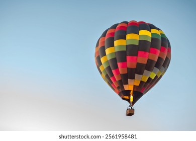 Colorful pattern hot air balloon in the skies over the Phoenix Arizona Sonoran Desert. Photo taken on a clear blue sky day