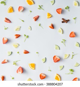 Colorful pattern made of citrus fruits, leaves and strawberries.