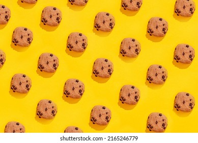 Colorful Pattern Of Sweet Cookies On Yellow Background. Top View. Flay Lay