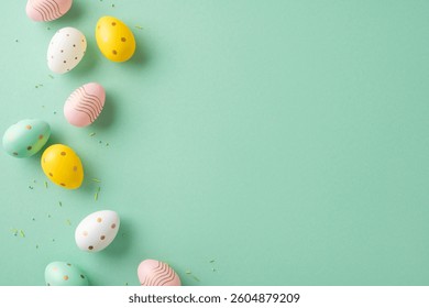 Colorful patterned Easter eggs are arranged on a green surface, symbolizing spring and celebration