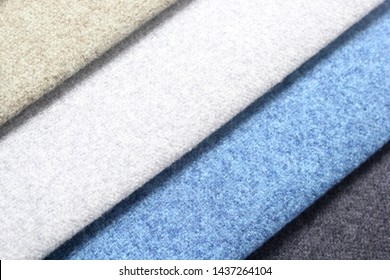 Colorful Patterns Of Upholstery Fabric. Close-up Of Samples Of Furniture Fabric. Felt Fabric Of Cold Shades. Furniture Industry. Fabric Swatches. Background Texture.