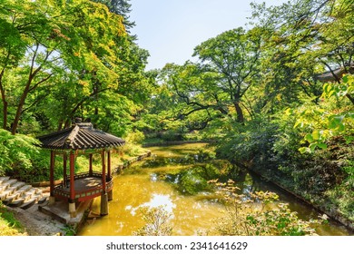 Colorful pavilion and scenic pond in Huwon Secret Garden of Changdeokgung Palace in Seoul, South Korea. Traditional Korean palatial architecture. The garden is a popular tourist attraction of Asia.