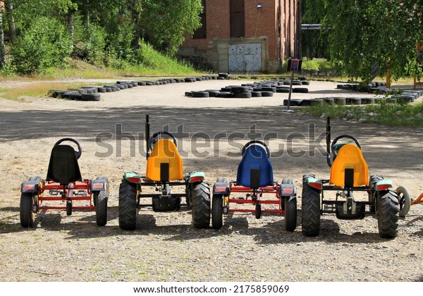 colorful  pedal cars in a\
row