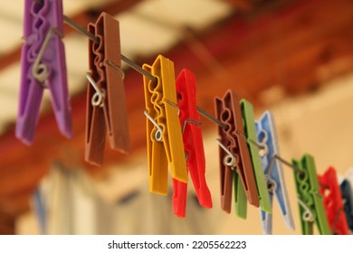 Colorful pegs on a white hanging rope. High quality photo
