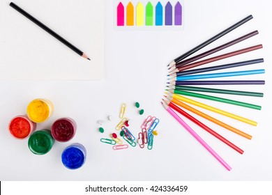 Colorful pencils, gouache paint, stickers, clips and pins on white background - Powered by Shutterstock