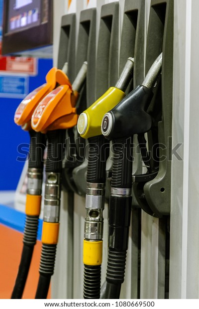 Colorful Petrol pump filling nozzles\
isolated on white background , Gas station in a\
service
