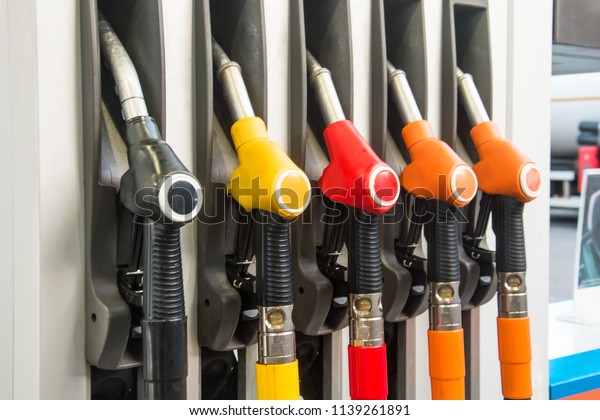 Colorful Petrol pump filling nozzles, refueling\
gas stations in a\
service