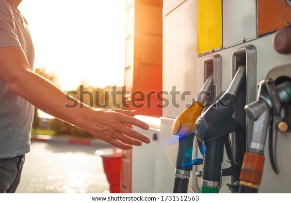 Colorful Petrol pump filling nozzles, Gas station\
in a service. Gas pump nozzles in service station. Fuel - Closed\
gas station - Shortage. Different types of fuel pumps identified\
with colors