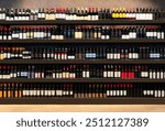 Colorful picture of many wine bottles on shelves in liquor store.  Alcohol industry. Wine shop background.