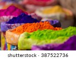 Colorful piles of powdered dyes used for Holi festival in India
