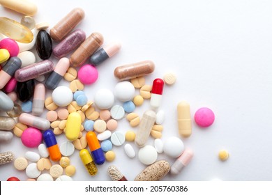 Colorful pills and  capsules on white