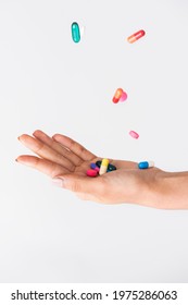 Colorful Pills Falling To A Palm