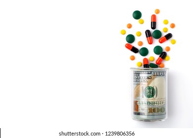 Colorful Pills Spilled From A Bottle Made Of Money, On White Background. The Concept Of Drug Purchase.