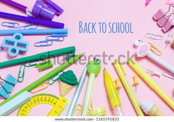 Colorful pink background with various School\
accessories are laid out in the form of a rainbow. Empty notebook.\
Flat lay top view. Study arrangement, making wish list or plans.\
Back to school text.