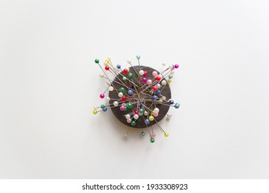 colorful pins on ring magnet isolated white background, magnetic pin cushion, tailor, sewing, fashion, design materials equipments, tools, diy, cloth fastening fabric, glass headed pin