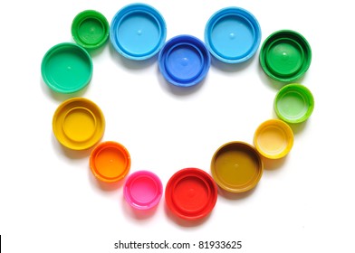 Colorful plastic bottle screw caps used to seal plastic bottles, arranged in heart shape - Shutterstock ID 81933625