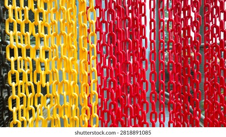 Colorful plastic chain pattern in red and yellow as an abstract background.