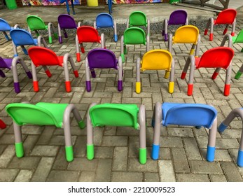 Colorful Plastic Chairs For Children Line Up Neatly In The Yard