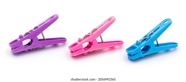 Colorful plastic clothespins or clothes pegs isolated on white background