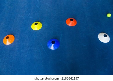 Colorful Plastic Cones On A Blue Cement Tennis Court. Top View. Horizontal Photo