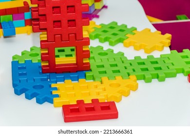 Colorful Plastic Constructor Set For Children. Multicolored Puzzle Blocks Of The Children's Constructor Are Connected Into Shapes. Concept Of Childhood And Games, Business And Cooperation