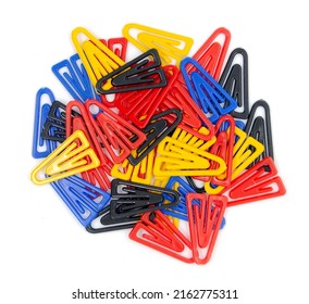 Colorful plastic paperclips isolated on white background, top view. Non metal red, yellow, blue, black triangle binder clips for children in school age. Education - office concept.
				