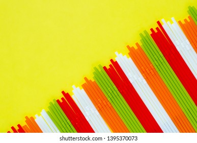 Colorful plastic straws on yellow background for summer season concept. - Powered by Shutterstock