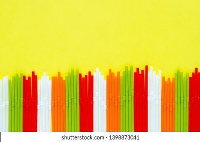 Colorful plastic straws on yellow background for summer season concept. - Powered by Shutterstock