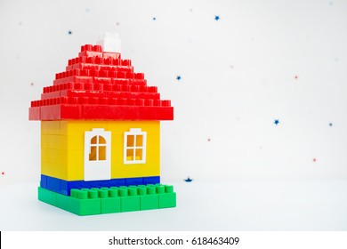 Colorful plastic Toy house from a designer on a light abstract background
