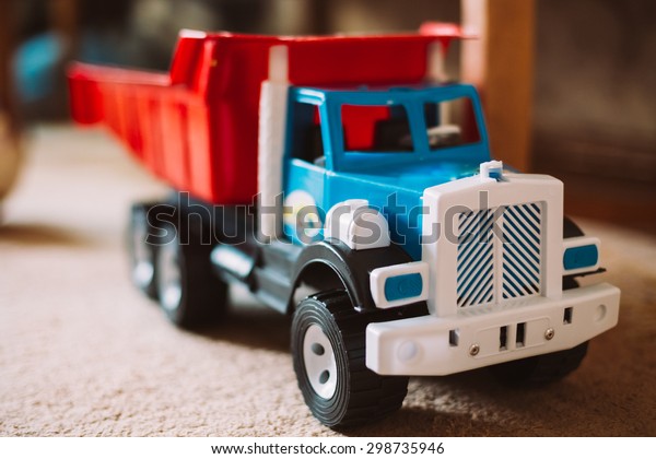 Colorful plastic toy\
truck on floor home