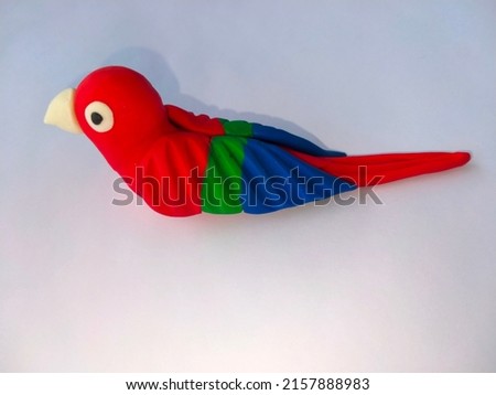 colorful plasticine clay macow parrot isolated on white background.plasticine world.Handmade modelling clay birds.