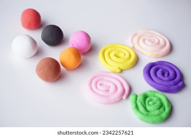 Colorful plasticine were sculpted into different shapes, balls and rolls. Concept, materials or tool for practicing imagination and brain development for kids.                                      - Powered by Shutterstock