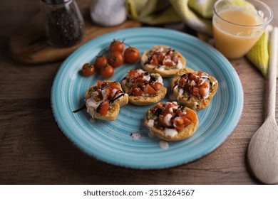 A colorful plate of bruschetta topped with diced tomatoes, cream, and balsamic glaze is served on a rustic wooden table. Fresh cherry tomatoes and a glass of juice complete the inviting meal. - Powered by Shutterstock