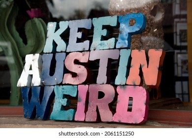Colorful plate with word Austin in front of a shop window  in SoCo, Austin