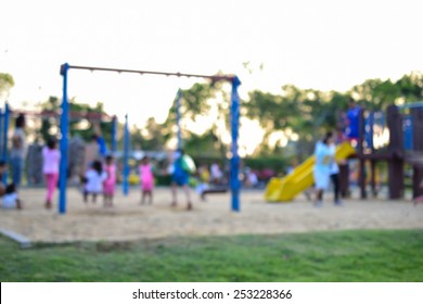 Colorful Playground With Children And Parents In Park (blur Background)