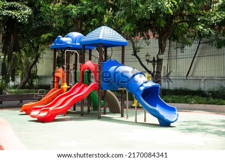 Colorful playground made of plastic empty outdoor playground set playground equipment. play area. Play area. Garden equipment. Children's slide. School yard. Playground in the park.
