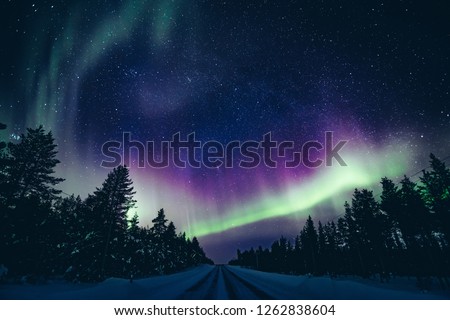 Colorful polar arctic Northern lights Aurora Borealis activity in winter Finland, Lapland