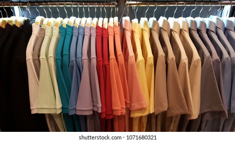 Colorful Polo Shirts Hanging On Clothing Rack In Store Closet.