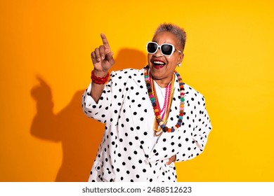 Colorful portrait of funny senior black woman wearing stylish clothing isolated in studio - Cool modern old female adult, concepts about elderly, 
 senior people and body positive - Powered by Shutterstock