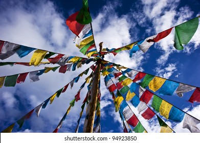 colorful prayer flag in tibet under blue sky and white cloud